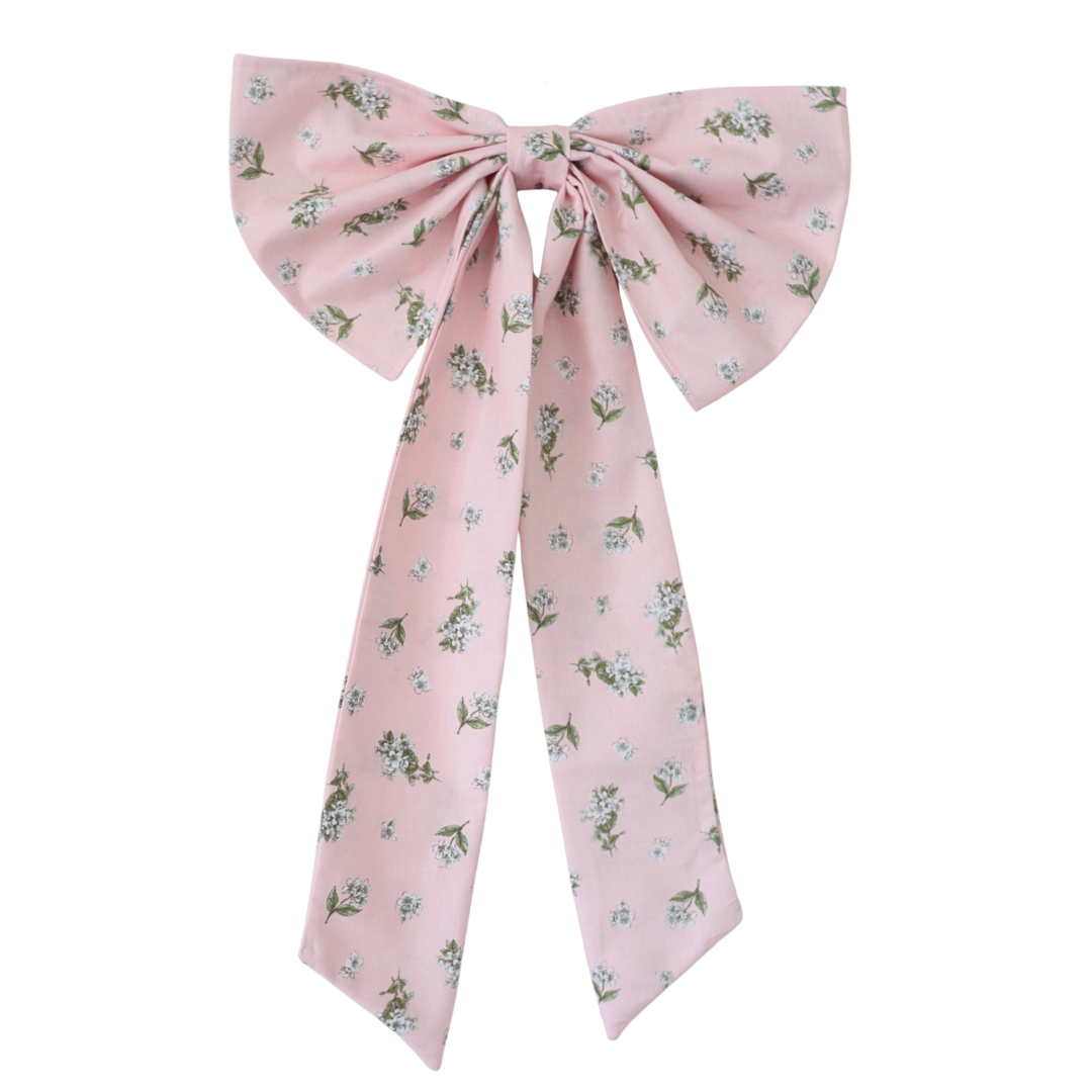 Pink floral bow on a white background
