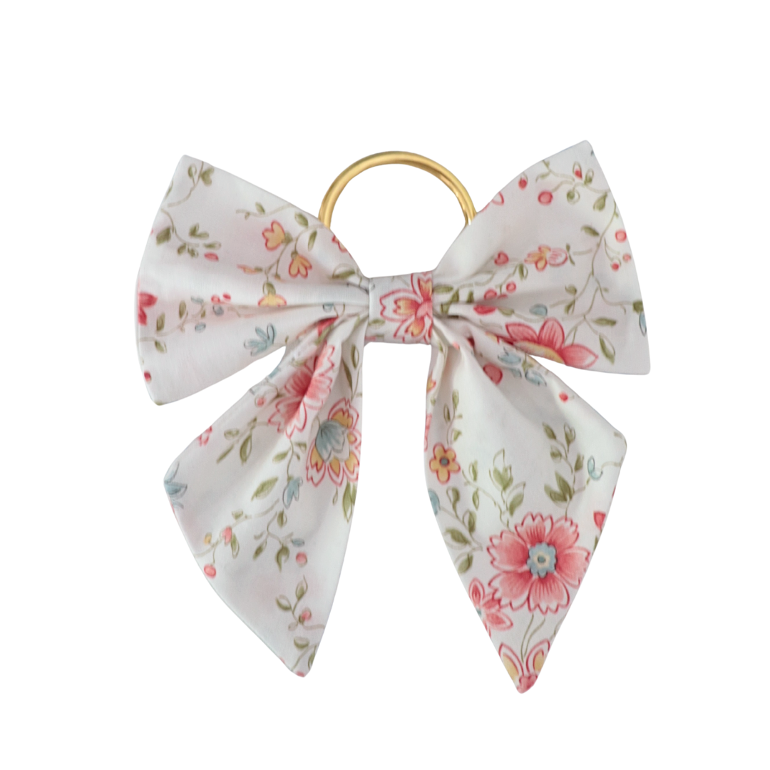 Floral-patterned bow hair clip on a white background