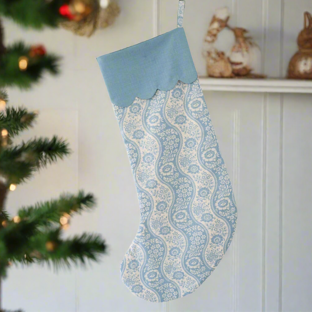 Decorative blue and white stocking with a paisley pattern on a white background