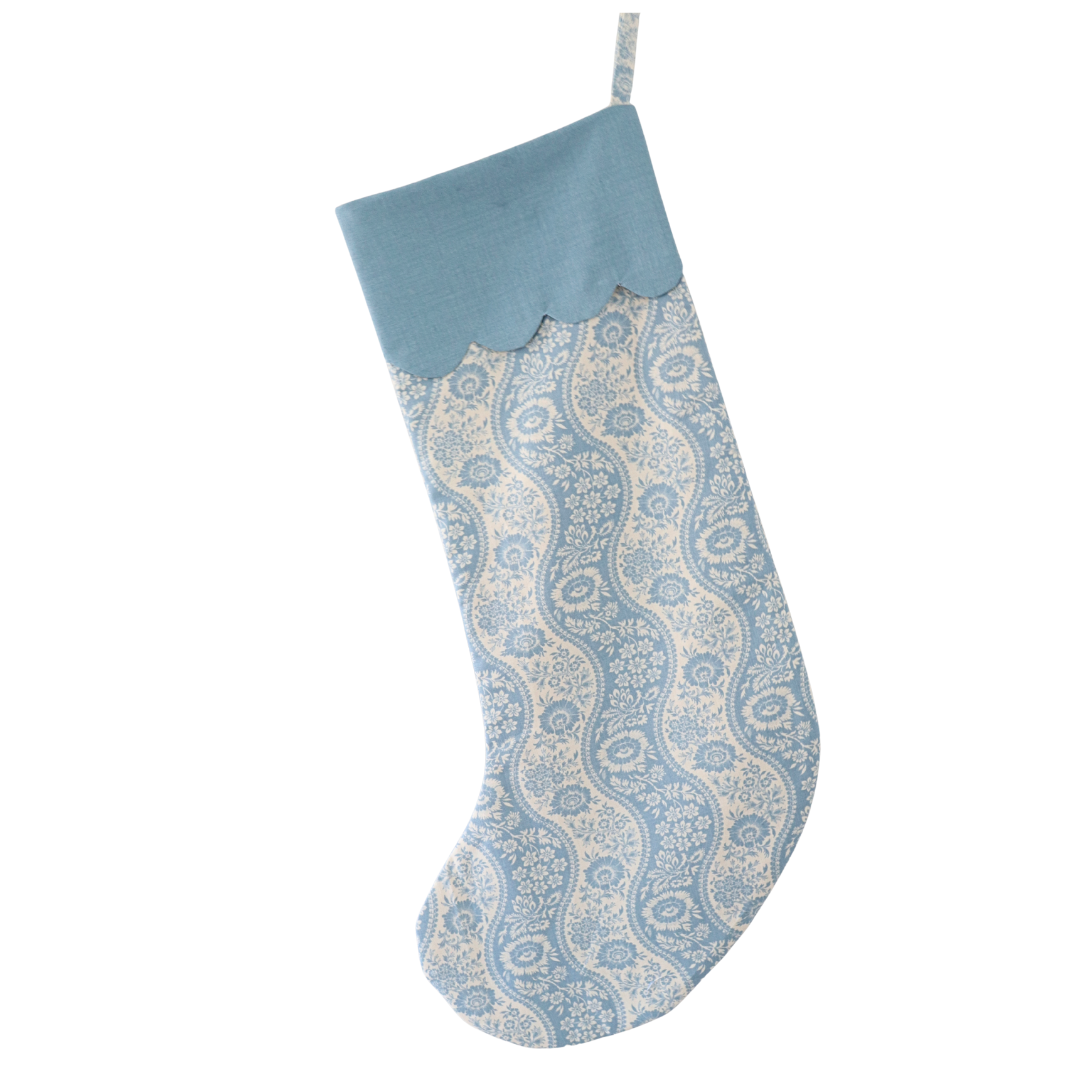 Decorative blue and white stocking with a paisley pattern on a white background