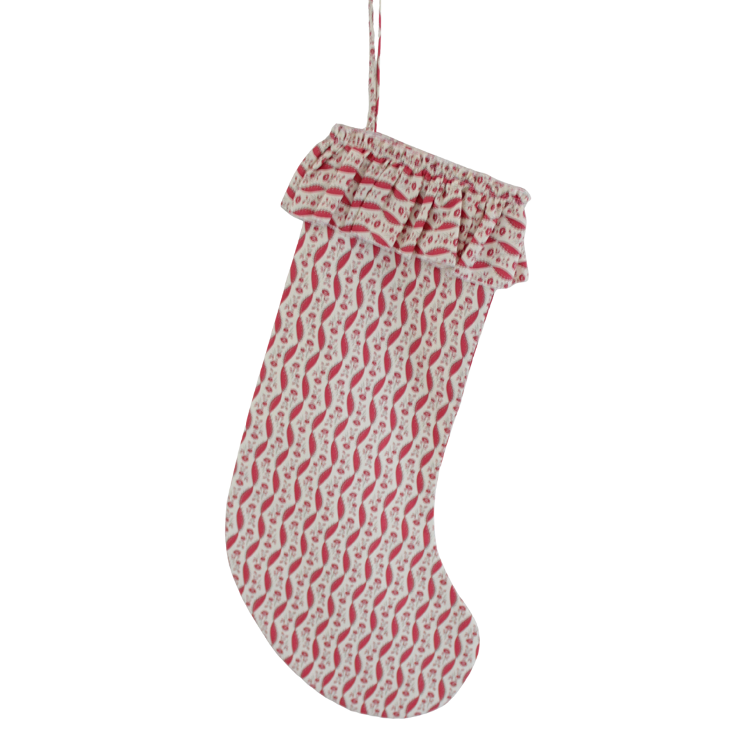 Red and white patterned Christmas stocking on a white background