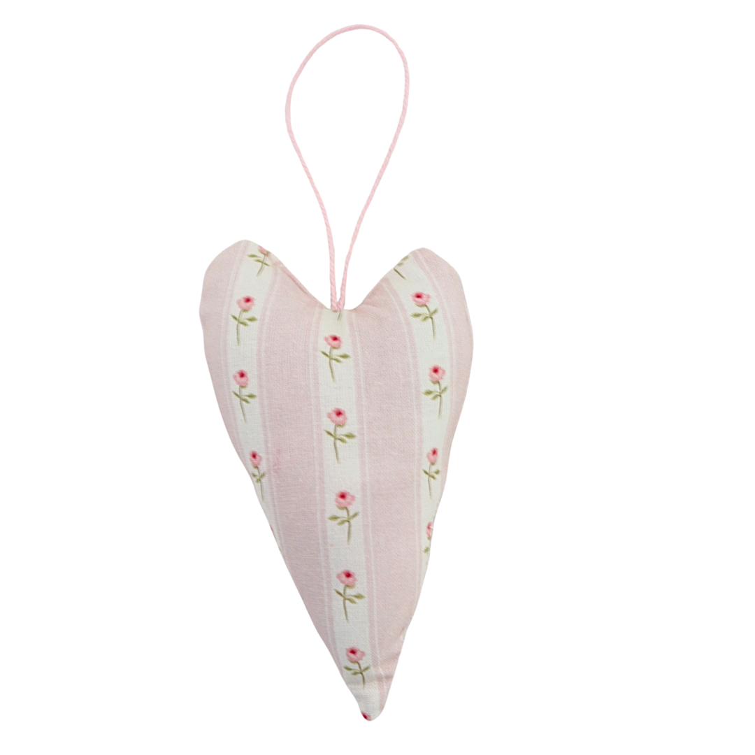 Heart-shaped decorative item with floral pattern on a white background