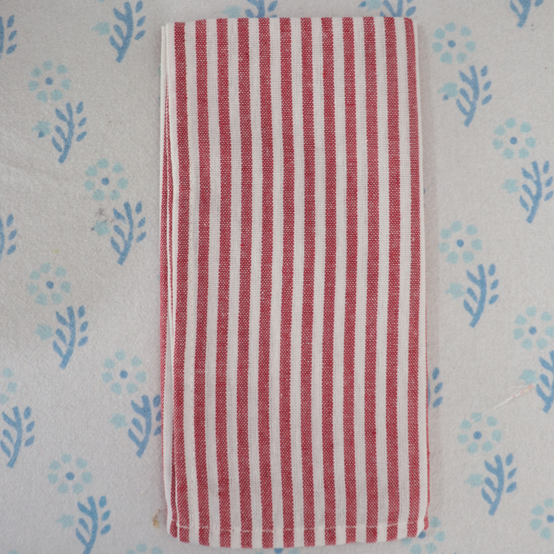 Red and white striped fabric on a patterned background