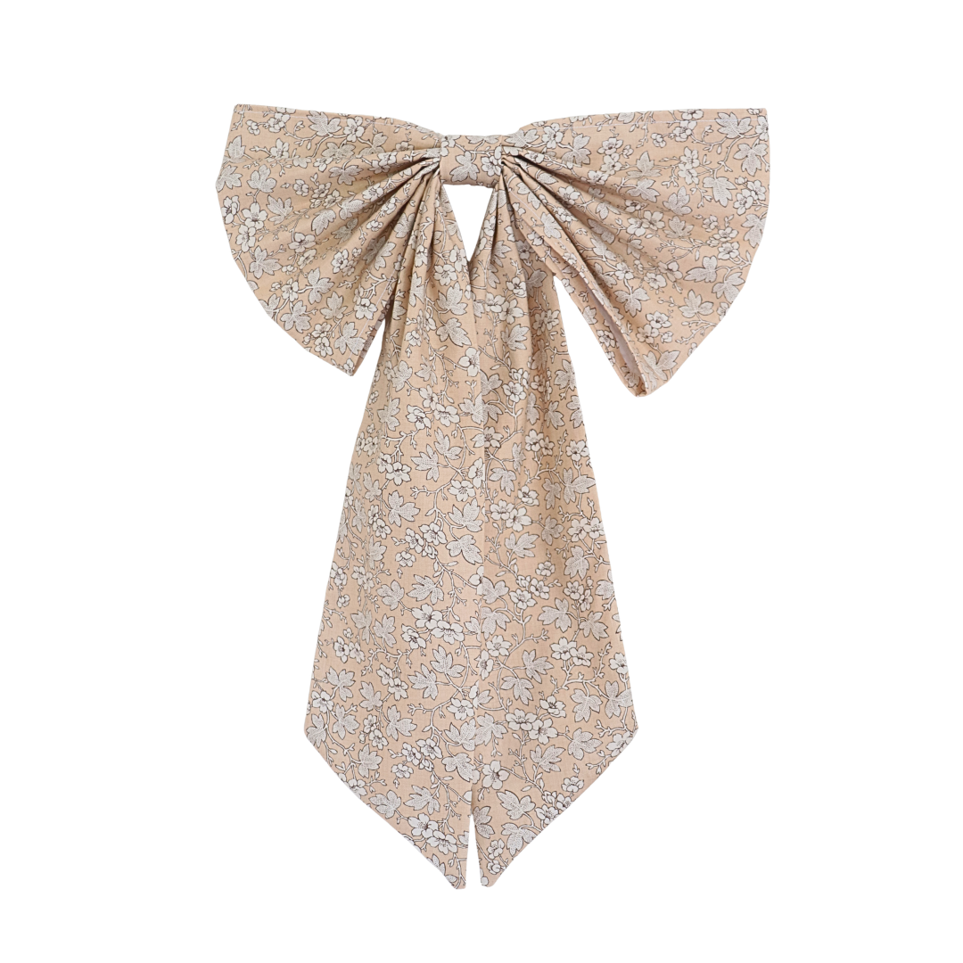 Floral patterned bow scarf on a white background
