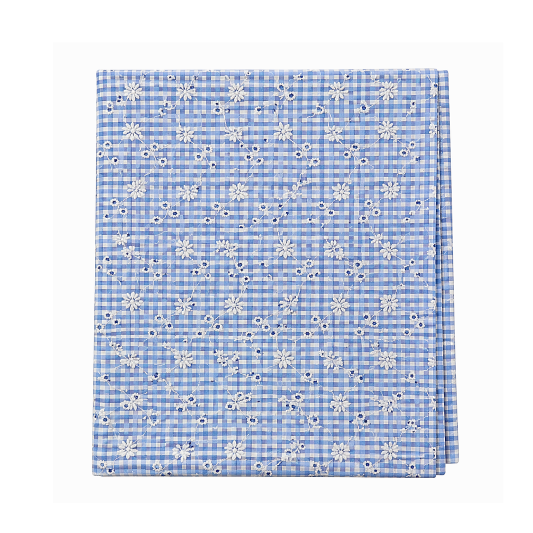 Blue checkered fabric with white floral pattern on a white background