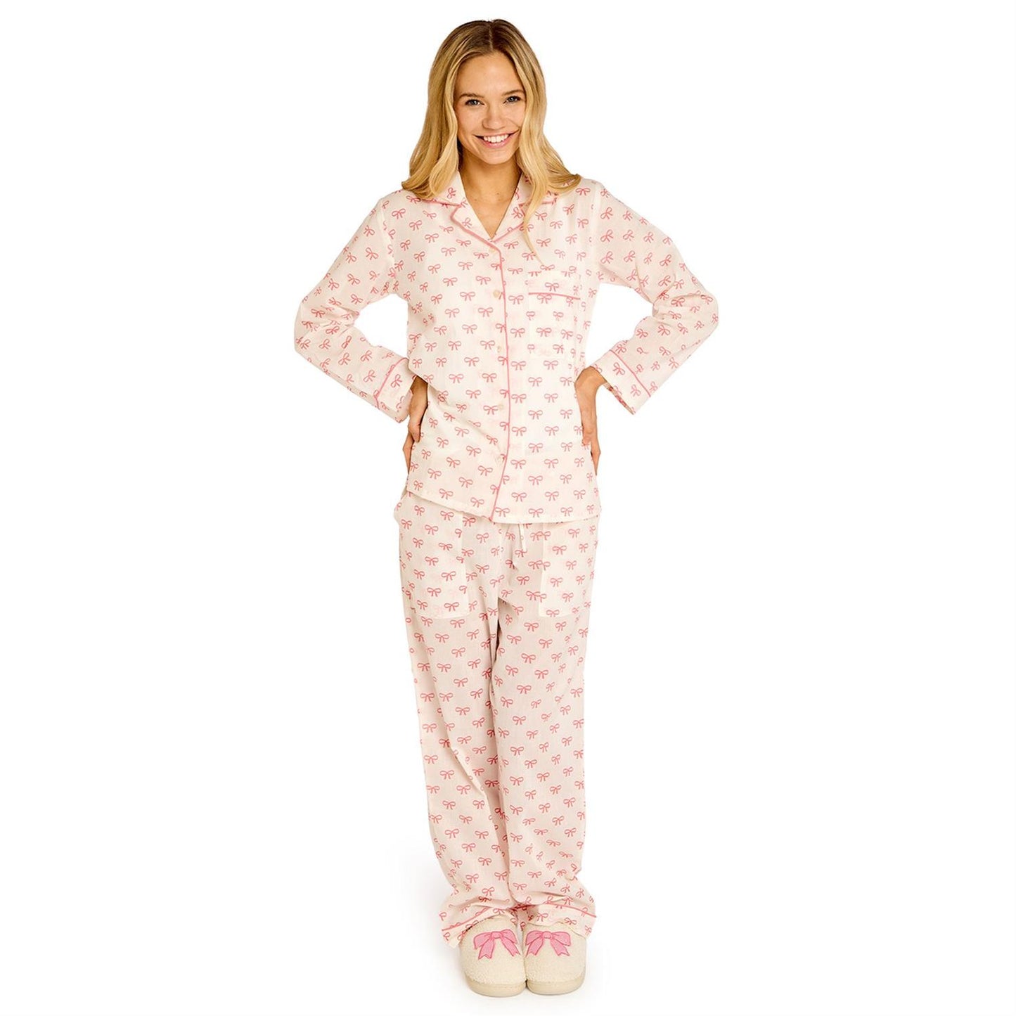 Woman wearing pink pajamas with a pattern on a white background