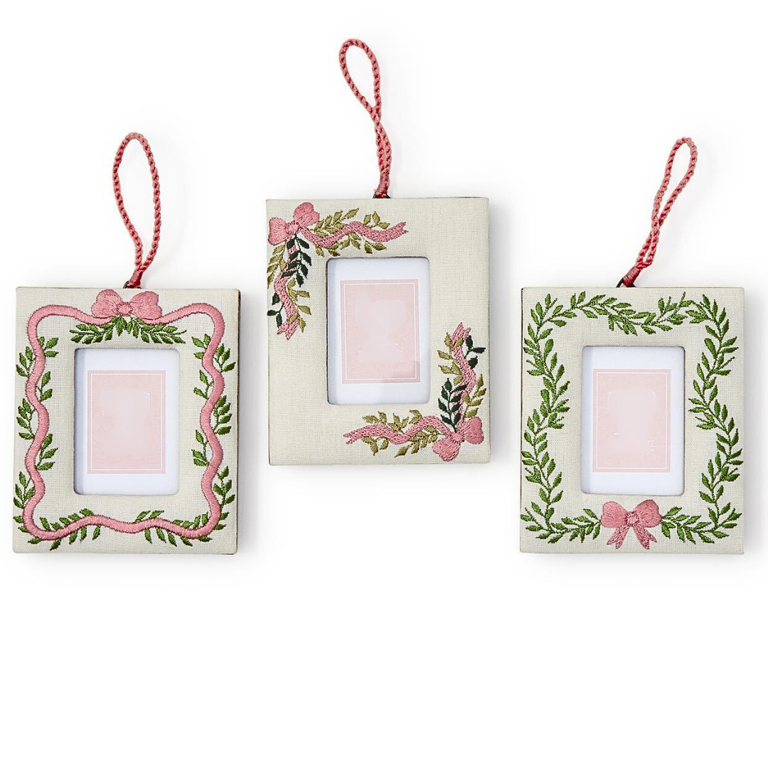 Set of three decorative picture frames with floral designs on a white background