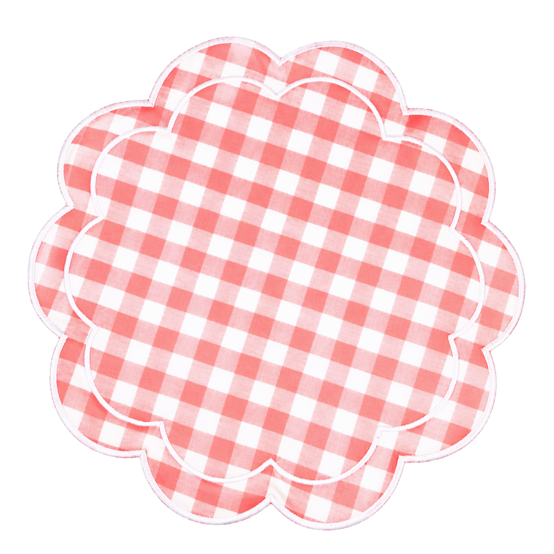 pink and white checkered placemat with scalloped edge on a white background