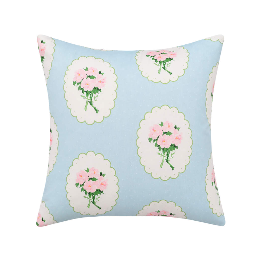 Decorative pillow with floral pattern on a light blue background