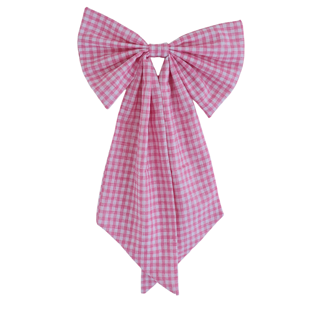 Pink gingham bow on a white background