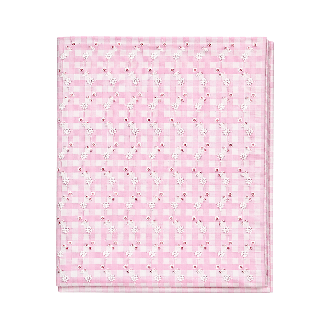 Pink checkered blanket with small white flowers on a white background
