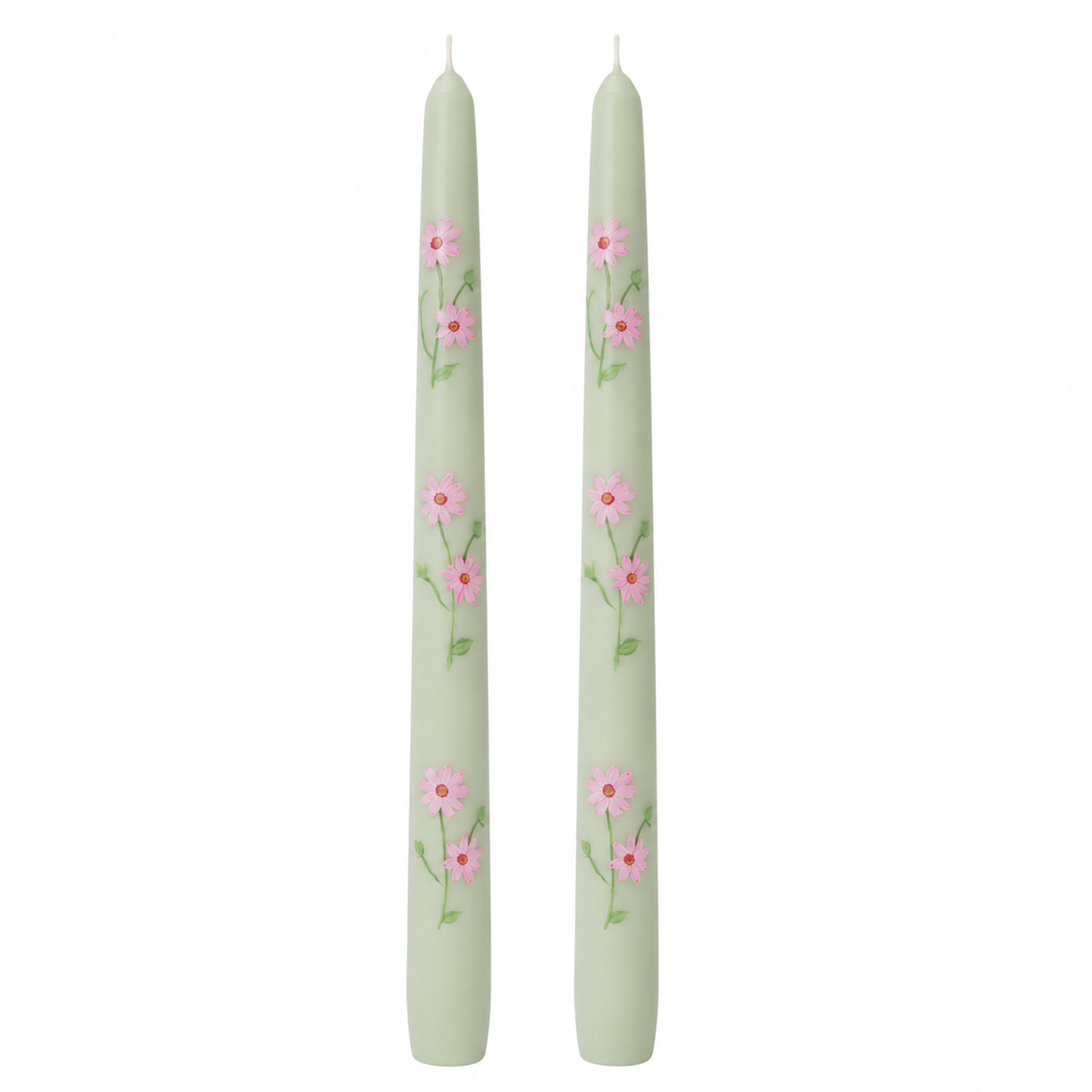 Two green candles with floral patterns on a white background
