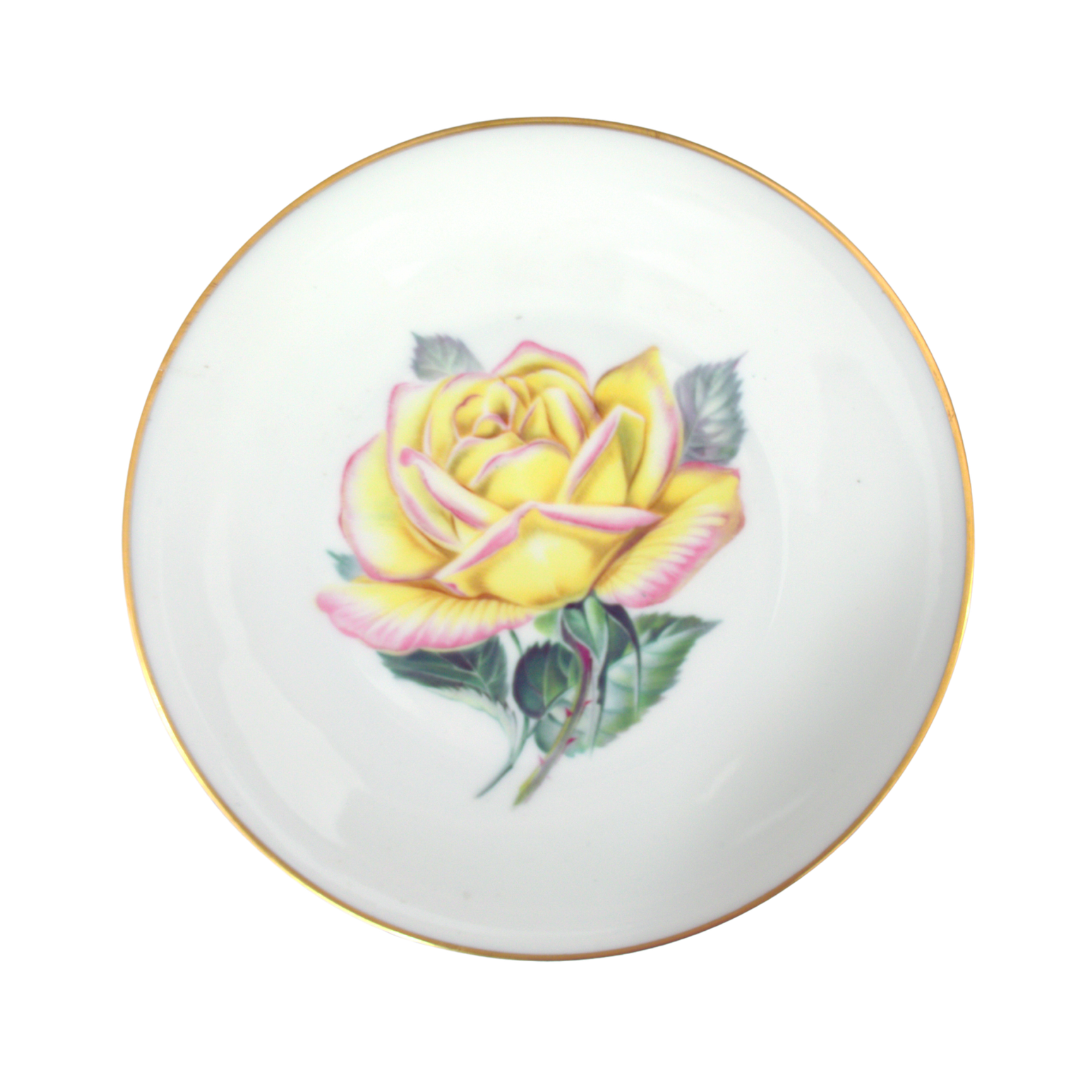 Decorative plate with a yellow rose design on a white background