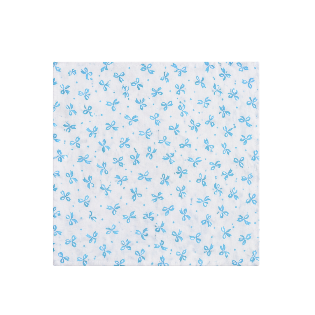 White napkin with blue bo pattern on a white background