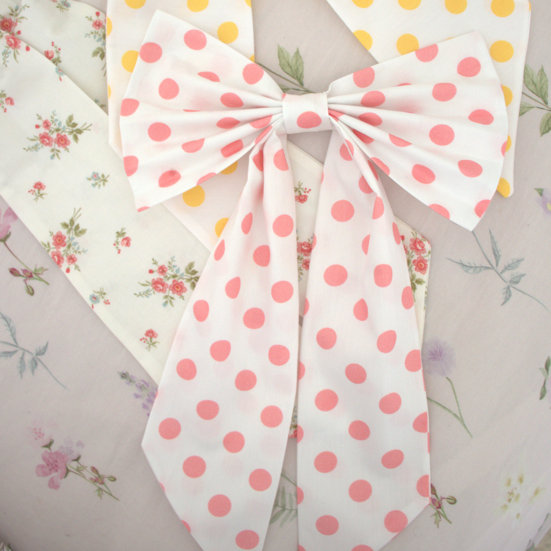 Polka dot bow with floral patterns in the background