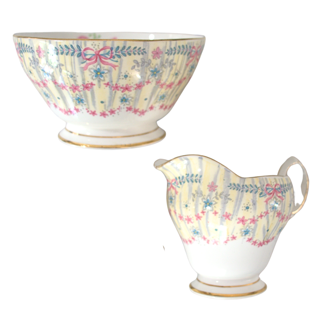 Decorative ceramic bowl and pitcher with floral patterns on a white background